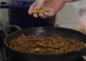 Bay leaves are added to the browned ground meat