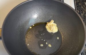 Butter melting in a wok, ready for cooking