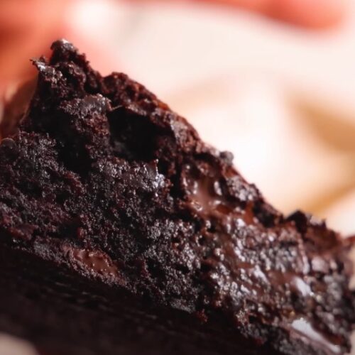 A rich, decadent brownie slice, glistening with melted chocolate